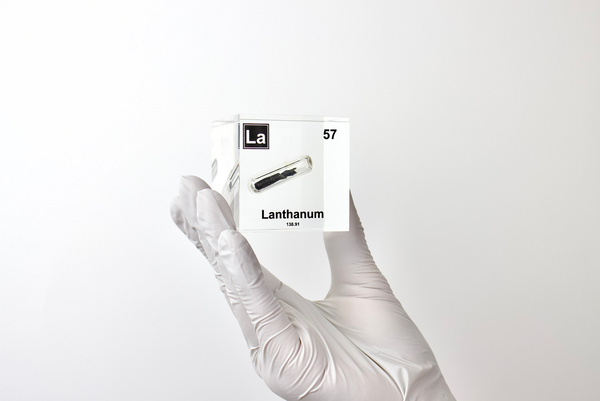 Clear acrylic cube displaying a Lanthanum element (Atomic Number 57) embedded within, offering a scientific presentation for collectors and science enthusiasts.