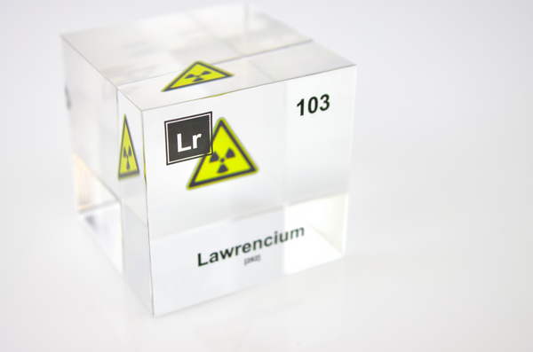 Clear acrylic cube displaying a Lawrencium element (Atomic Number 103) embedded within, offering a scientific presentation for collectors and science enthusiasts.