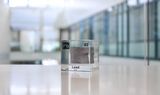 Clear acrylic cube displaying a Lead element (Atomic Number 82) embedded within, offering a scientific presentation for collectors and science enthusiasts.