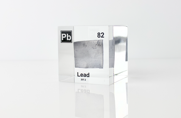 Clear acrylic cube displaying a Lead element (Atomic Number 82) embedded within, offering a scientific presentation for collectors and science enthusiasts.