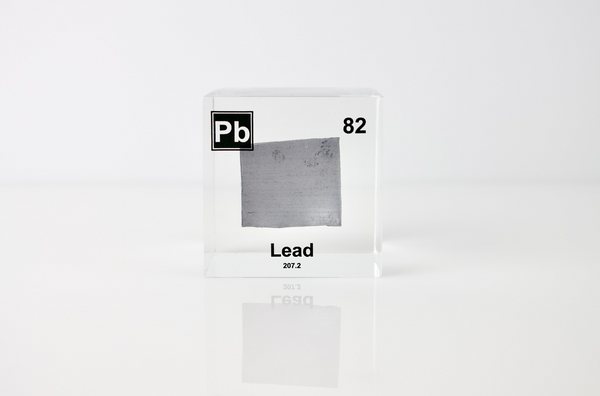 Clear acrylic cube displaying a Lead element (Atomic Number 82) embedded within, offering a scientific presentation for collectors and science enthusiasts.