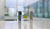Clear acrylic cube displaying a Livermorium element (Atomic Number 116) embedded within, offering a scientific presentation for collectors and science enthusiasts.