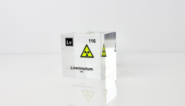 Clear acrylic cube displaying a Livermorium element (Atomic Number 116) embedded within, offering a scientific presentation for collectors and science enthusiasts.