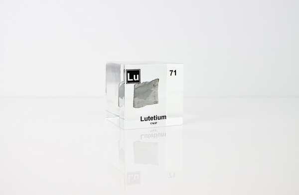 Clear acrylic cube displaying a Lutetium element (Atomic Number 71) embedded within, offering a scientific presentation for collectors and science enthusiasts.