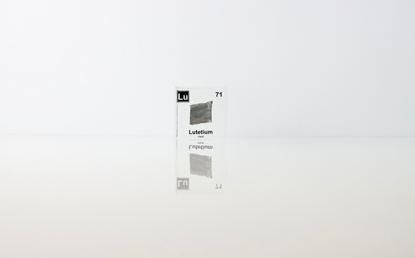 Clear acrylic cube displaying a Lutetium element (Atomic Number 71) embedded within, offering a scientific presentation for collectors and science enthusiasts.