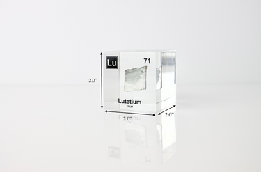 Clear acrylic cube displaying a Lutetium element (Atomic Number 71) embedded within, offering a scientific presentation for collectors and science enthusiasts.