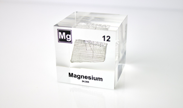 Clear acrylic cube featuring a Magnesium ampule with its atomic number 12. Ideal for educational displays, scientific collections, or as a distinctive decorative item.