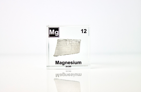 Clear acrylic cube featuring a Magnesium ampule with its atomic number 12. Ideal for educational displays, scientific collections, or as a distinctive decorative item.