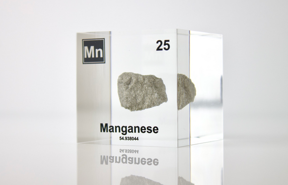 Manganese element in a clear acrylic cube, showcasing its name, atomic number, and properties as displayed on the periodic table. A stylish and informative piece for collectors and educators.