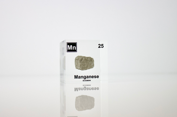 Manganese element in a clear acrylic cube, showcasing its name, atomic number, and properties as displayed on the periodic table. A stylish and informative piece for collectors and educators.