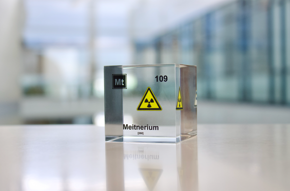 Clear acrylic cube displaying a Meitnerium element (Atomic Number 109) embedded within, offering a scientific presentation for collectors and science enthusiasts.