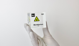 Clear acrylic cube displaying a Mendelevium element (Atomic Number 101) embedded within, offering a scientific presentation for collectors and science enthusiasts.