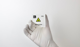 Clear acrylic cube displaying a Moscovium element (Atomic Number 115) embedded within, offering a scientific presentation for collectors and science enthusiasts.