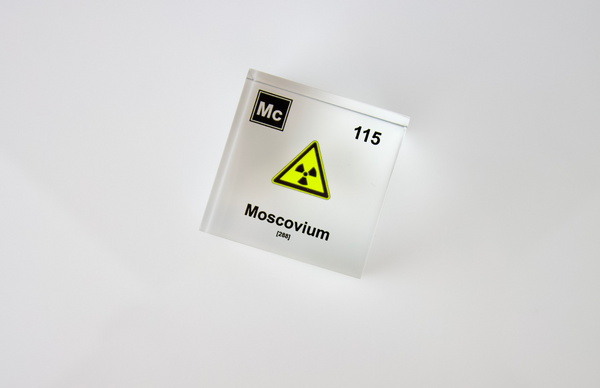 Clear acrylic cube displaying a Moscovium element (Atomic Number 115) embedded within, offering a scientific presentation for collectors and science enthusiasts.