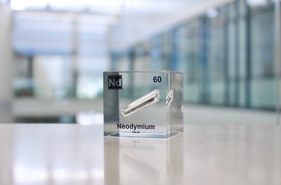 Clear acrylic cube displaying a Neodymium element (Atomic Number 60) embedded within, offering a scientific presentation for collectors and science enthusiasts.