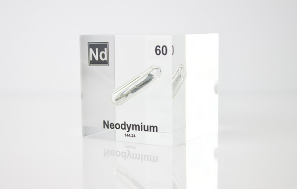 Clear acrylic cube displaying a Neodymium element (Atomic Number 60) embedded within, offering a scientific presentation for collectors and science enthusiasts.