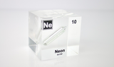 Clear acrylic cube encasing a Neon ampule with its atomic number 10. Ideal for display in educational settings, scientific collections, or as a decorative piece.