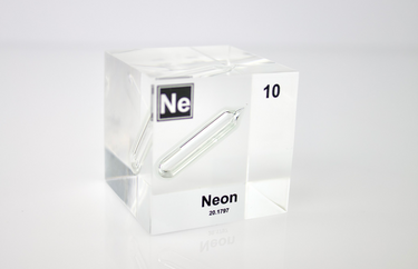 Clear acrylic cube encasing a Neon ampule with its atomic number 10. Ideal for display in educational settings, scientific collections, or as a decorative piece.