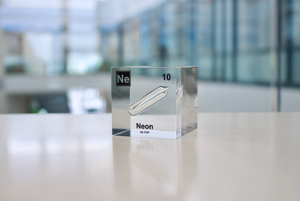 Clear acrylic cube encasing a Neon ampule with its atomic number 10. Ideal for display in educational settings, scientific collections, or as a decorative piece.