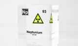 Clear acrylic cube displaying a Neptunium element (Atomic Number 93) embedded within, offering a scientific presentation for collectors and science enthusiasts.