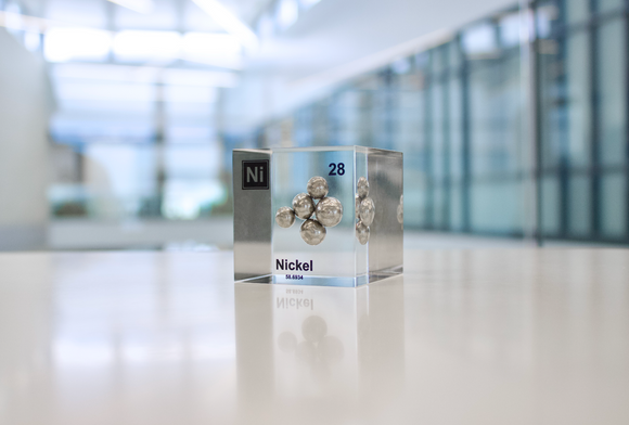 Nickel element, atomic number 28, in a clear acrylic cube, displaying its name, atomic number, and key properties as shown on the periodic table. An educational and informative piece ideal for science enthusiasts and collectors.