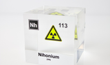 Clear acrylic cube displaying a Nihonium element (Atomic Number 113) embedded within, offering a scientific presentation for collectors and science enthusiasts.
