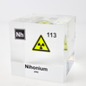 Clear acrylic cube displaying a Nihonium element (Atomic Number 113) embedded within, offering a scientific presentation for collectors and science enthusiasts.