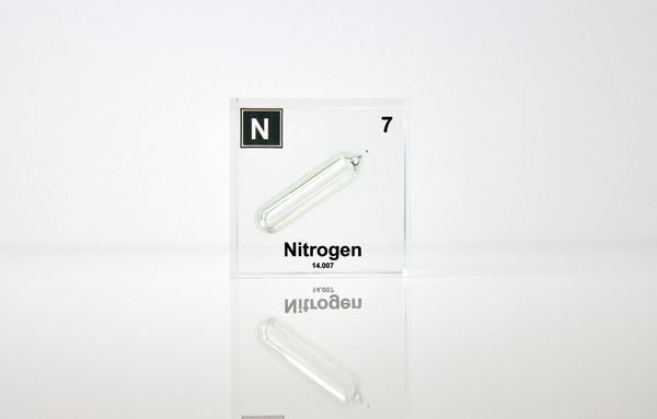 Clear acrylic cube encasing a Nitrogen ampule with its atomic number 7. Ideal for display in educational settings, scientific collections, or as a decorative piece.