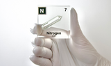 Clear acrylic cube encasing a Nitrogen ampule with its atomic number 7. Ideal for display in educational settings, scientific collections, or as a decorative piece.