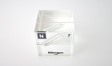 Clear acrylic cube encasing a Nitrogen ampule with its atomic number 7. Ideal for display in educational settings, scientific collections, or as a decorative piece.