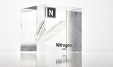 Clear acrylic cube encasing a Nitrogen ampule with its atomic number 7. Ideal for display in educational settings, scientific collections, or as a decorative piece.