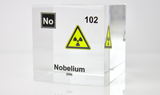 Clear acrylic cube displaying a Nobelium element (Atomic Number 102) embedded within, offering a scientific presentation for collectors and science enthusiasts.