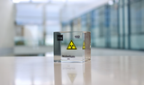 Clear acrylic cube displaying a Nobelium element (Atomic Number 102) embedded within, offering a scientific presentation for collectors and science enthusiasts.
