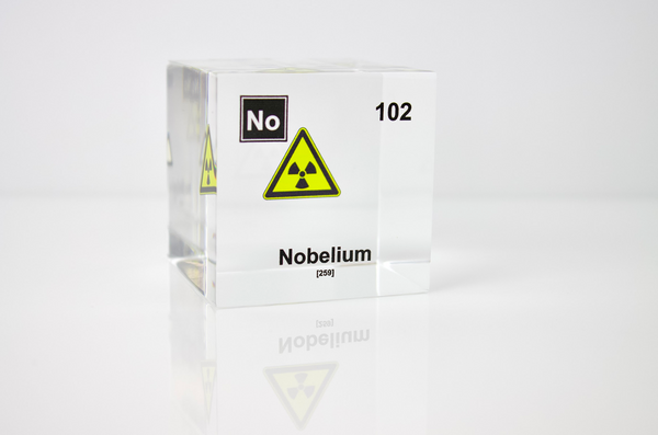 Clear acrylic cube displaying a Nobelium element (Atomic Number 102) embedded within, offering a scientific presentation for collectors and science enthusiasts.