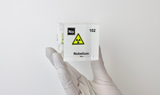 Clear acrylic cube displaying a Nobelium element (Atomic Number 102) embedded within, offering a scientific presentation for collectors and science enthusiasts.