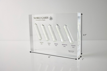 Close-up of a noble gas display made of acrylic. The display features several sections, each containing a different noble gas in its inert, gaseous form, with clear labels identifying each gas. 