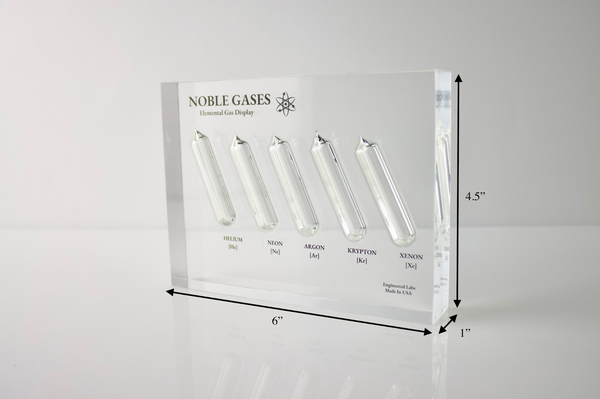 Close-up of a noble gas display made of acrylic. The display features several sections, each containing a different noble gas in its inert, gaseous form, with clear labels identifying each gas. 