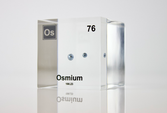 Piece of Osmium encased in a clear acrylic cube, with the element's name, atomic number, and properties displayed as on the periodic table for a sleek, educational display.