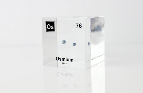 Piece of Osmium encased in a clear acrylic cube, with the element's name, atomic number, and properties displayed as on the periodic table for a sleek, educational display.