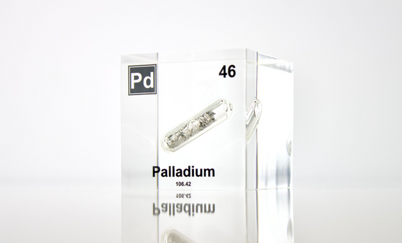 Clear acrylic cube displaying a Palladium element (Atomic Number 46) embedded within, offering a scientific presentation for collectors and science enthusiasts.