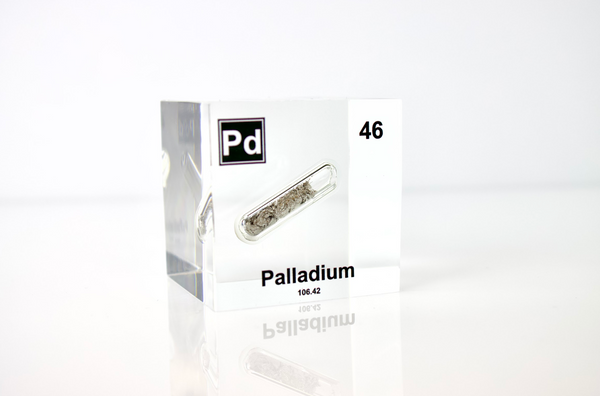 Clear acrylic cube displaying a Palladium element (Atomic Number 46) embedded within, offering a scientific presentation for collectors and science enthusiasts.