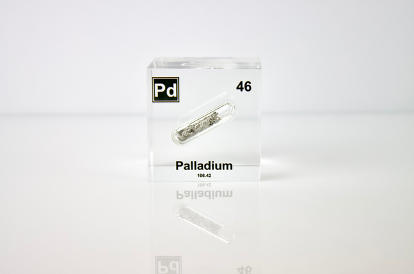 Clear acrylic cube displaying a Palladium element (Atomic Number 46) embedded within, offering a scientific presentation for collectors and science enthusiasts.