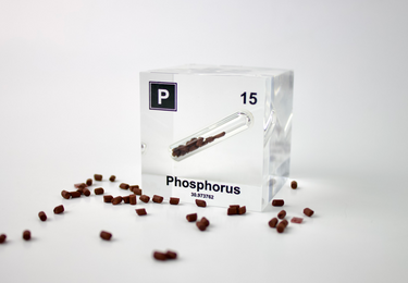 Clear acrylic cube displaying a Phosphorus element (Atomic Number 15) embedded within, offering a scientific presentation for collectors and science enthusiasts.