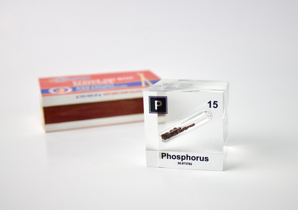 Clear acrylic cube displaying a Phosphorus element (Atomic Number 15) embedded within, offering a scientific presentation for collectors and science enthusiasts.