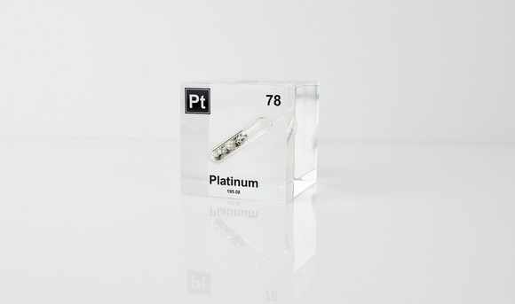 Clear acrylic cube displaying a Platinum element (Atomic Number 78) embedded within, offering a scientific presentation for collectors and science enthusiasts.