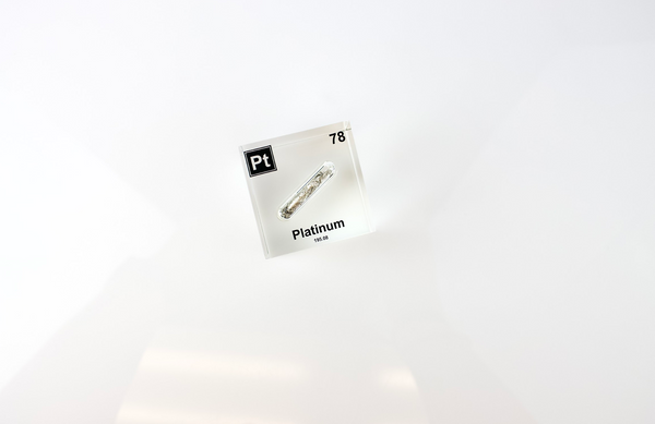 Clear acrylic cube displaying a Platinum element (Atomic Number 78) embedded within, offering a scientific presentation for collectors and science enthusiasts.