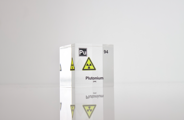 Clear acrylic cube displaying a Plutonium element (Atomic Number 94) embedded within, offering a scientific presentation for collectors and science enthusiasts.