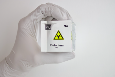 Clear acrylic cube displaying a Plutonium element (Atomic Number 94) embedded within, offering a scientific presentation for collectors and science enthusiasts.