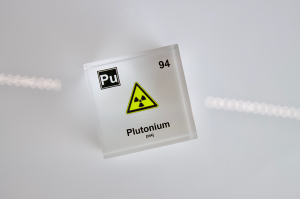 Clear acrylic cube displaying a Plutonium element (Atomic Number 94) embedded within, offering a scientific presentation for collectors and science enthusiasts.