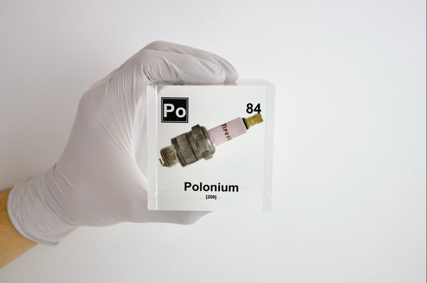 Clear acrylic cube showcasing a Polonium element (Atomic Number 84) embedded within, providing a scientific display for collectors and science enthusiasts.